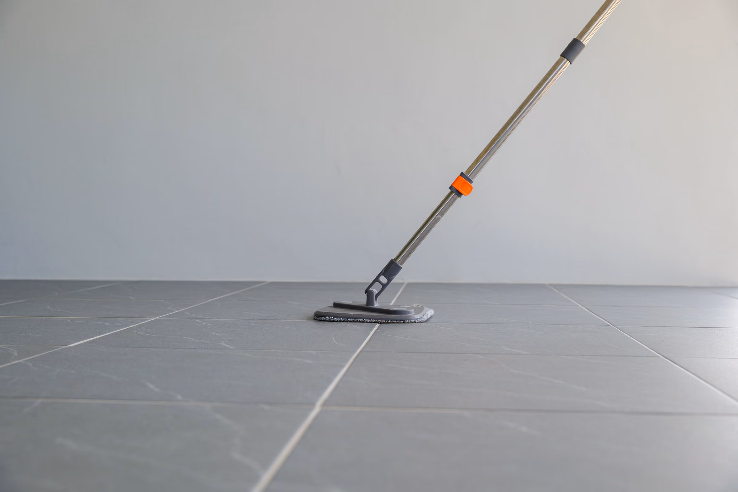 Limpieza de suelo porcelánico Limpieza de suelo porcelánico: mopa sobre baldosa gris de gran formato